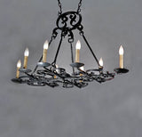 A rustic wrought iron chandelier featuring intricate scrollwork and traditional candle-style lights. It has a classic design that adds elegance to any space.