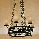 A stunning wrought iron chandelier featuring a circular design with intricate leaf motifs. It includes four frosted glass shades and is suspended by a decorative chain, adding elegance and warmth to any space.