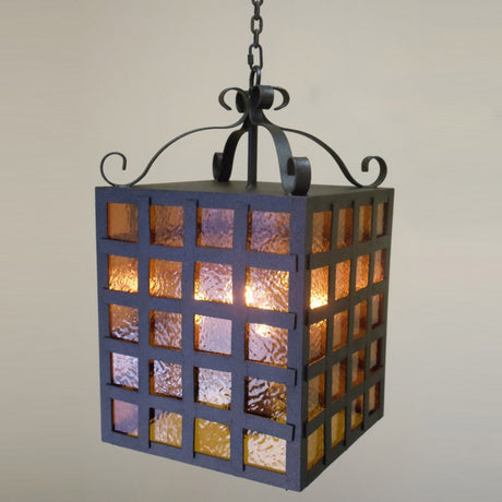 A beautifully crafted wrought iron pendant light featuring a square shape with textured, colored glass panels. The fixture hangs gracefully from a stylish chain, adding warmth and charm to any space.