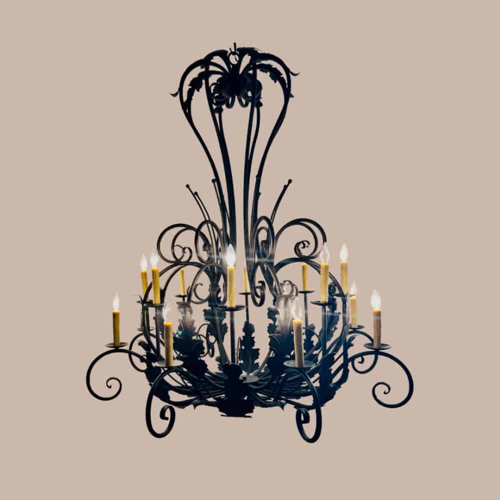 A stunning wrought iron chandelier featuring intricate scrollwork and floral motifs. It showcases multiple candle-like lights that create an elegant, warm ambiance, perfect for enhancing any interior space.