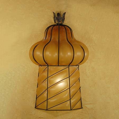 A beautifully crafted wall sconce featuring an intricate wrought iron frame with a warm amber glass body resembling a flowing, organic shape. This elegant fixture adds a touch of artistry and warmth to any space, enhancing the overall ambiance with its unique design.