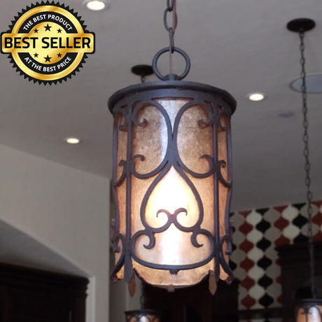 A decorative pendant light with an intricate wrought iron design, featuring a cylindrical shape and warm, glowing interior. Ideal for enhancing home ambiance.