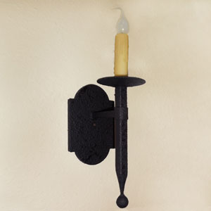 A sleek wrought iron wall sconce featuring a textured backplate and a candle holder with a tapered design, adding elegant warmth to any space.