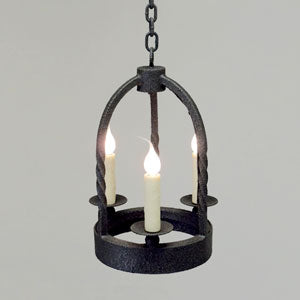 A wrought iron pendant featuring three slender candle-like bulbs within a circular base. The design showcases twisted rods and a robust frame, emphasizing elegance and rustic charm. Ideal for enhancing ambiance in various settings.